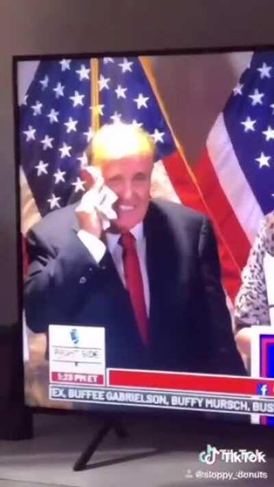 Rudy Giuliani smears snot all over his face