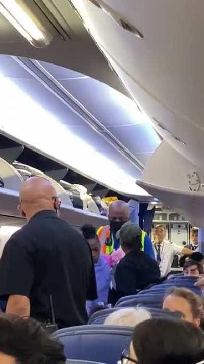 Freakout on plane. Gets kicked off plane then slaps me on the way out. We missed our connection flight because of this nonsense.