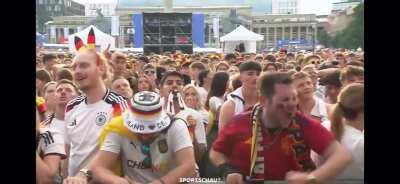 Spanish fan celebrating the winning 2:1 goal in a german public viewing crowd