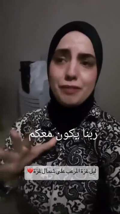 Palestinian women telling how much the zionists have gone crazy and she doesn't know what she should do while a heavy firing and strikes sounds around. 