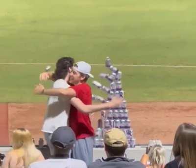 These two men spent the game making a pyramid out of stacked cans, only for someone to knock it over with a ball. I feel sorry for them.