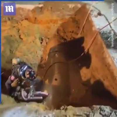 Rescuers dig up road to save dog trapped in drainage pipe