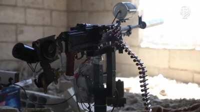 ISIS militant shooting a makeshift remote control machine gun. Raqqa, 2017