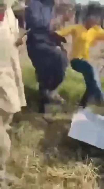 Villagers attack a drone in Pakistan.