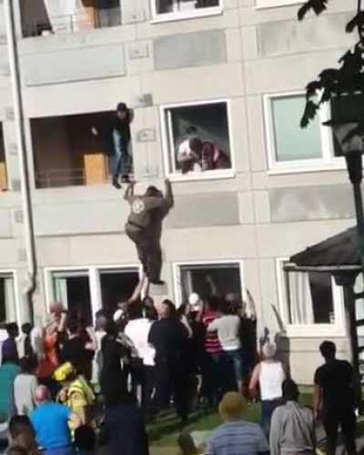 Saving a woman from a building on fire
