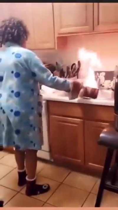 Woman tries putting out a grease fire with water