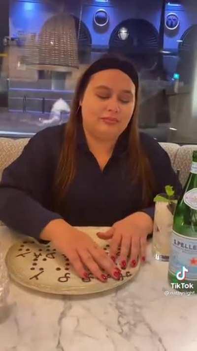 Restaurant staff wishes a blind woman happy birthday