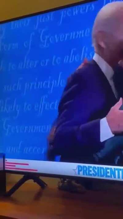 Joe Biden gets a hug from Jill Biden. Trump tries to force something from Melania.