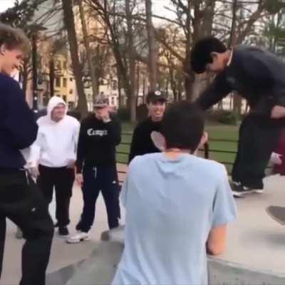 Fellow skateboarders help kid get over his fear of going down the ramp.