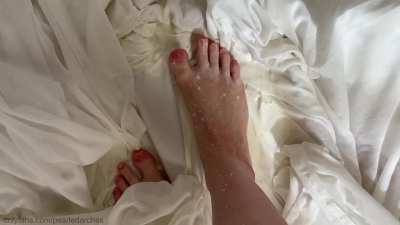 Feet in milk puddles, wet and messy.