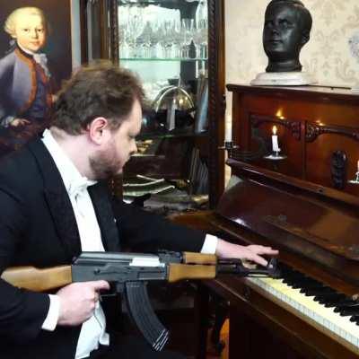 Man plays piano with AK-47