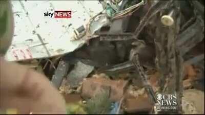Tornado survivor finds dog buried alive under rubble in the middle of a news interview.