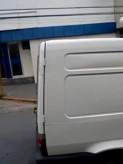 Man carrying another man in cardboard box