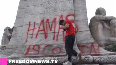 Pro Hamas protestors deface monument “Hamas is coming” as Protesters cheer