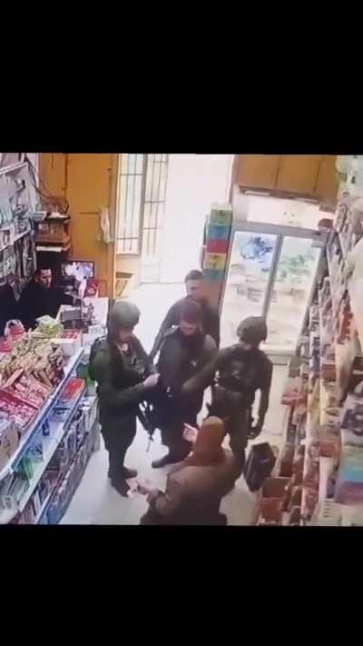 Israeli soldiers strip a Palestinian child of his shirt and assault him, terrorizing him and his family while shopping in the city of Hebron, occupied West Bank