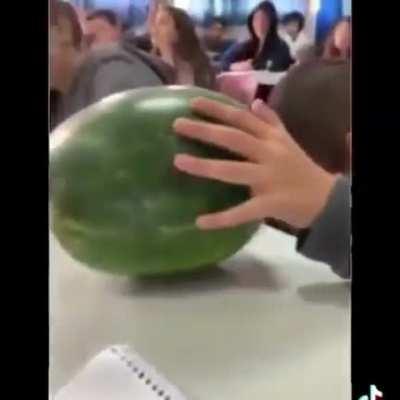 Kid receives permission from the teacher to eat a fruit during class.
