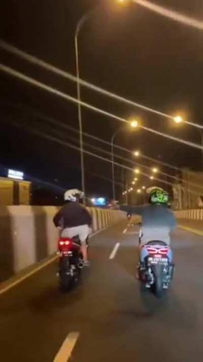 Horsing around while riding a motorcycle.