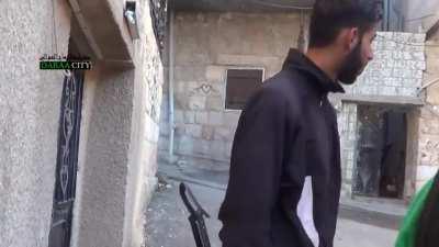 FSA fighters crossing the street show remarkably little emotion to incoming rifle fire - Daraa City, 2013