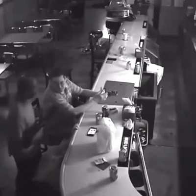 Man with balls of steel doesn't even flinch even when at gunpoint. Lights ciggie instead.