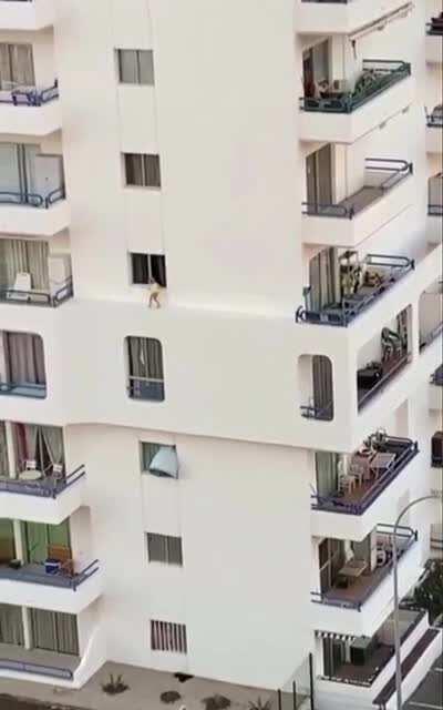 Kid plays on ledge. Tenerife, Spain.