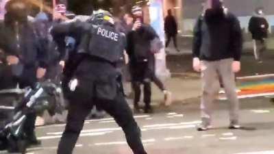 Seattle cop takes a bat to the helmet.