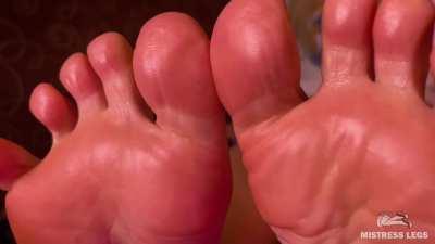 Oiled soles and toes wiggling