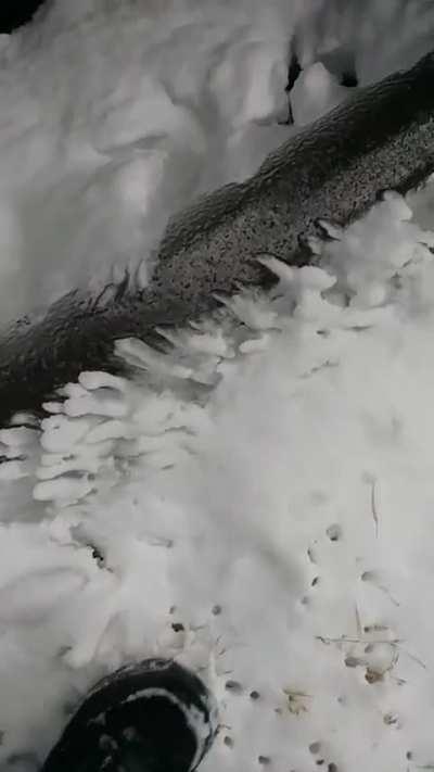 Ice tunnel made by water spraying out of a pin-size hole in the freezing cold