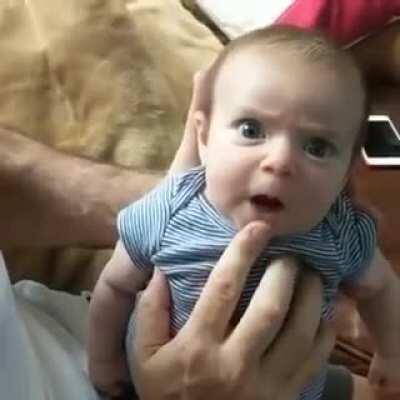 Baby funny/cute reaction to dad's goofiness.