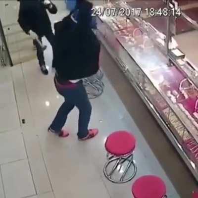 Bunch of thieves trying to break the glass protecting the jewellery