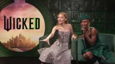 During the Wicked press junket, Ariana Grande and Cynthia Erivo react to learning that the interviewer (Carla Renata) was in Avenue Q during its Broadway run