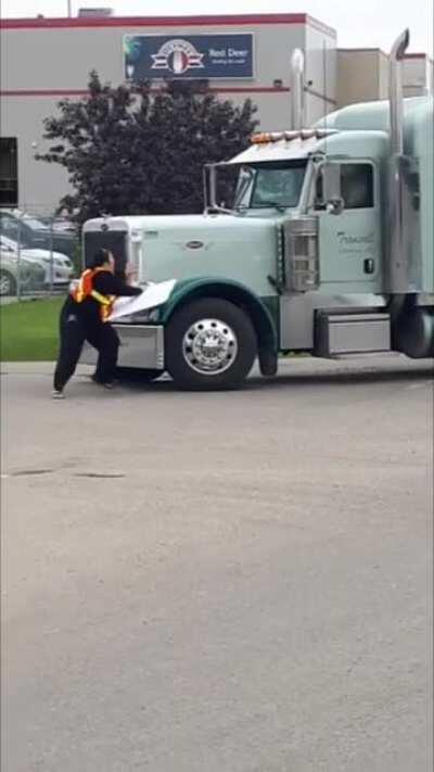 Chubby vegan protester gets bumped by a truck. Driver gives a happy thumbs up.
