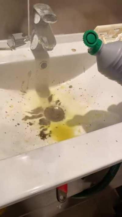 Pours “drain cleaner” into sink in an enclosed space