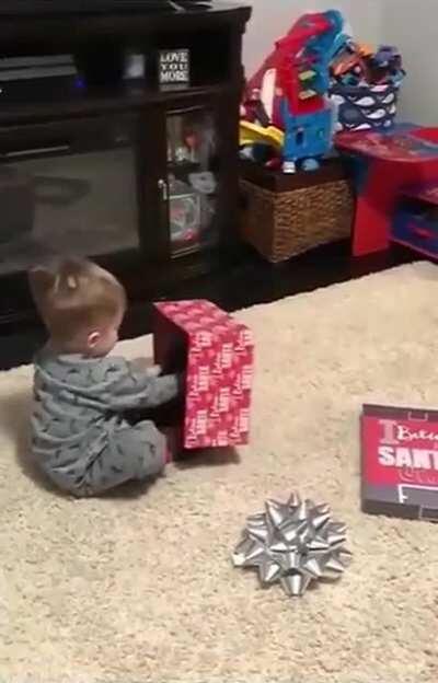 Baby doing a baby voice to a puppy