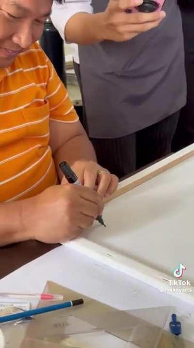 Art teacher grades his students drawing