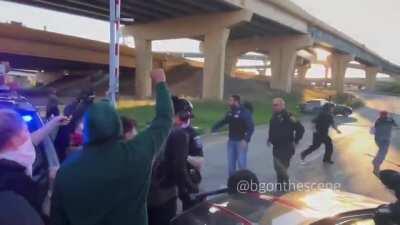 Protesters overwhelm a police line and make their way to the highway In Wauatosa