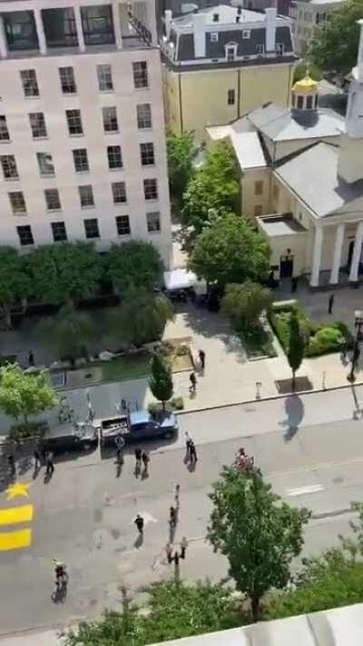 Painters create a massive two-block banner reading 'Black Lives Matter' on 16th Street leading towards the White House