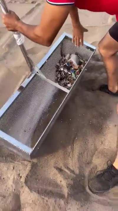 Cleaning up a beach by extracting small plastics from sand