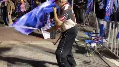 Trump supporters holding 'Blue lives matter' flags while dancing to Rage Against The Machine's 