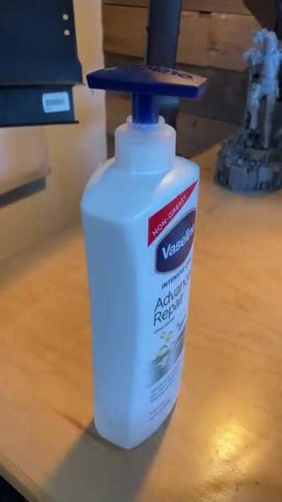 This perfectly symmetrical lotion bottle pump top that dispenses on the back