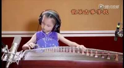 6 year old playing the Koto with the arm moves and posture of someone playing from the 1800s.