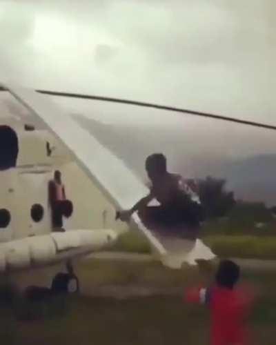 A boy playing on the MI8 helicopter's rotor