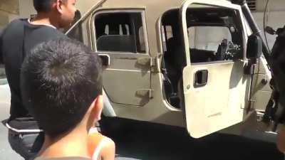 Heavily armed Israeli soldiers arrest a Palestinian child