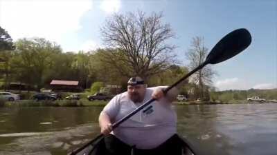 Fat guy Moans in a canoe