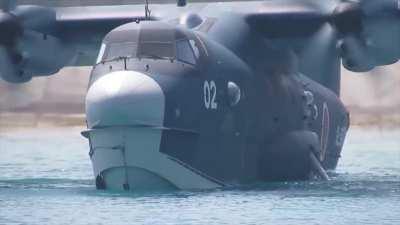 ShinMaywa US-2 STOL amphibian rolls into the water for a short take-off