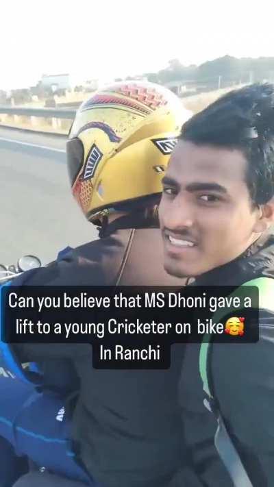 MS Dhoni giving a lift to a young cricketer on his bike.