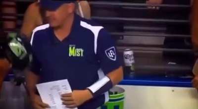 Man coaching a bikini football team like it’s the Super Bowl 