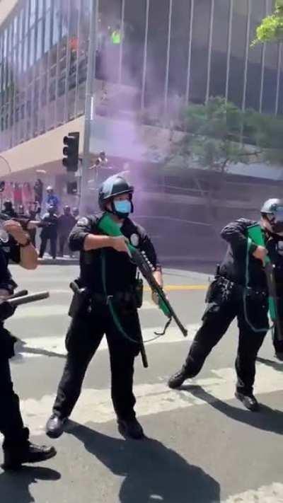 Cop shoots protester with a rubber bullet after she asked them to put the guns down