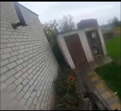 Ukrainian soldier clearing an outdoor toilet.