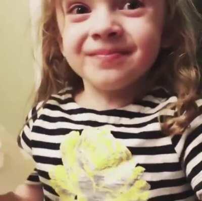 This little girl pretending to like mommy’s cooking