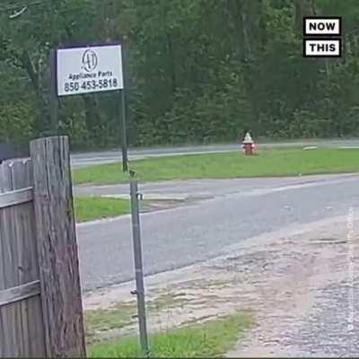 Surveillance footage shows the moment an 11-year-old girl fought off an attempted kidnapper as she waited for her school bus